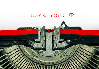 typewriter with sample text I LOVE YOU and heart