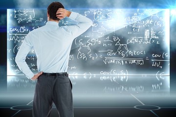 Composite image of thinking businessman with hand on head