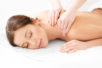 Fototapeta na wymiar Massage. Close-up of a Beautiful Woman Getting Spa Treatment