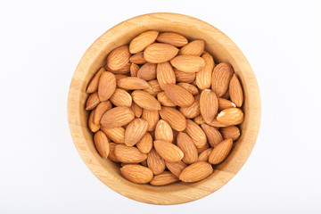 Almond nuts in wooden bowl isolated on white background
