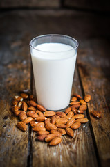 Almond milk on rustic wooden table