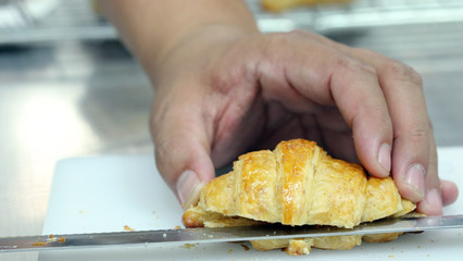 Hand cutting croissant