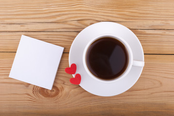 Obraz na płótnie Canvas Cup of coffee and two hearts.