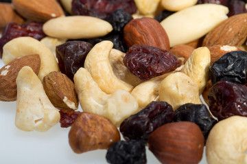 mixed nuts and dried fruits isolated on white background