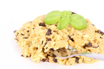 Risotto with mushrooms eaten with a fork on a white background