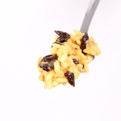 Risotto with mushrooms on a fork on white background