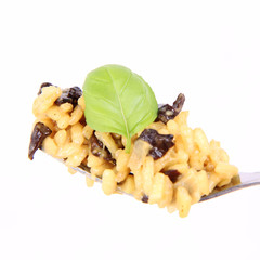 Risotto with mushrooms on a plate decorated with basil