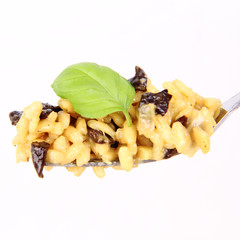 Risotto with mushrooms on a plate decorated with basil