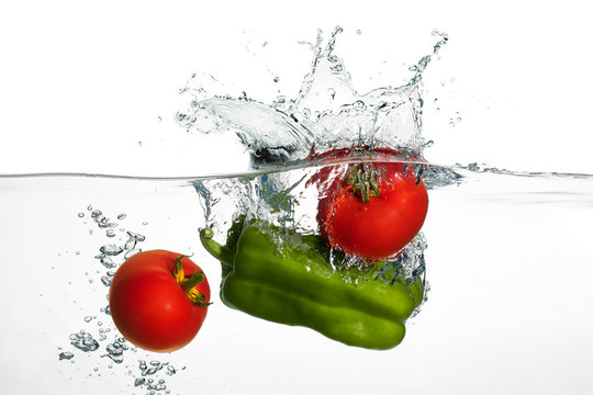 Fresh Tomatoes and Green Pepper Splash in Water Isolated on Whit