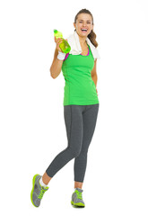 Full length portrait of fitness woman with bottle of water