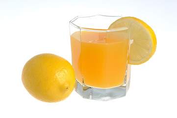 One lemon with glass with a slice of lemon filled with citrus ju