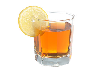 Glass with a slice of lemon filled with lemon tea on white