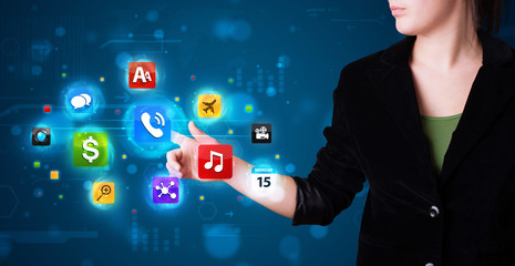 Woman pressing various collection of high tech buttons