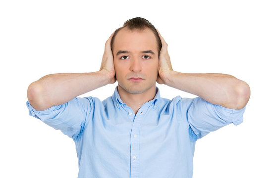 Man covering ears, hear no evil, avoiding situation, conflict