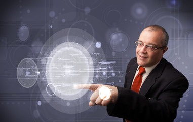 Businessman touching abstract high technology circular buttons
