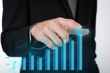 Business man pressing high tech type of modern graph on a virtua