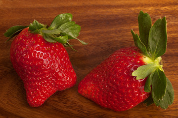 Two strawberries on wood,