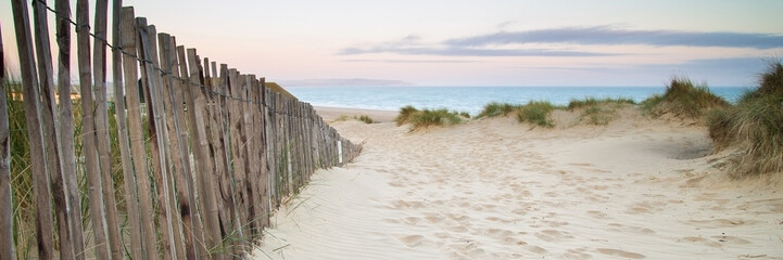 Panorama landscape of sand dunes system on beach at sunrise