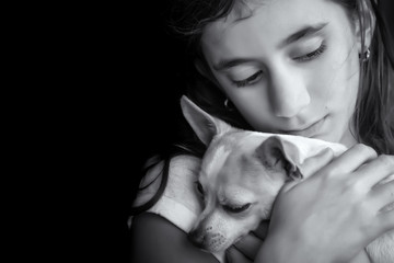 Motional portrait of a sad lonely girl hugging her small dog - 61096880