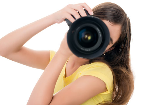 Girl using a professional camera isolated on white