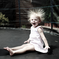 Little girl jumping in trampoline