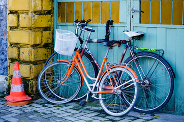 Fototapeta na wymiar Two old bicycles standing near the wall