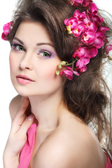 Obraz na płótnie Canvas Portrait of beautiful sexual brunette with pink orchids in hairs
