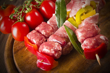 skewers of chicken and sausage on the chopping board