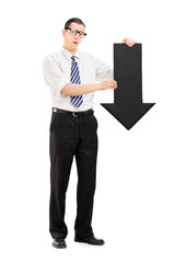 Sad man holding a big black arrow pointing down