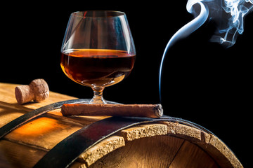 Aroma of Cuban cigars and cognac on black background