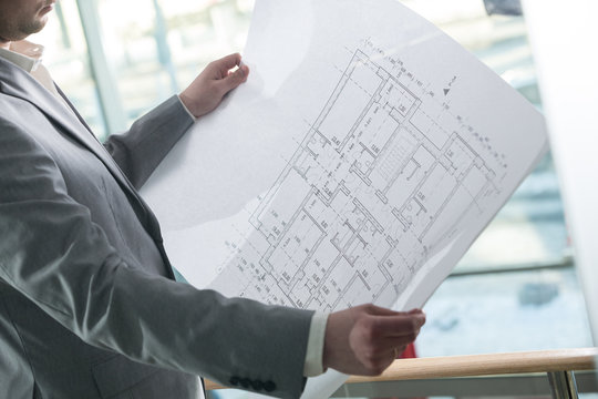 architectural plan in the architect's hands