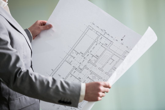architectural plan in the architect's hands