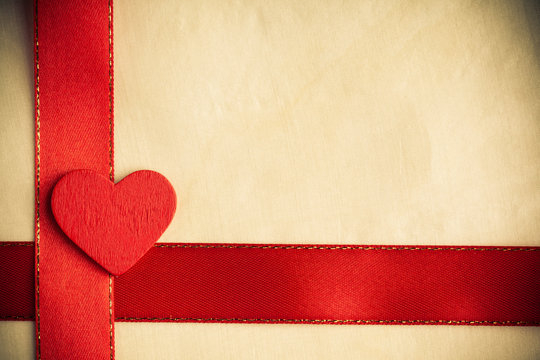 Valentines day background. Red satin ribbon and heart.