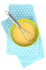 Corolla and broken eggs in bowl isolated on white