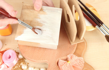 Handmade wooden box and art materials for decor, on table