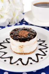 Sweet cake with chocolate on plate on table close-up