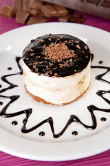 Sweet cake with chocolate on plate on table close-up