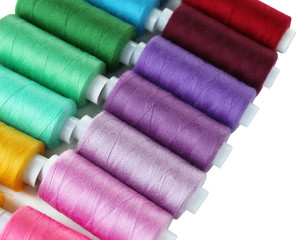 Colored spools of threads close up