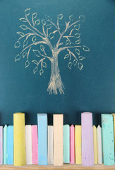 Colorful chalks and drawing on school desk