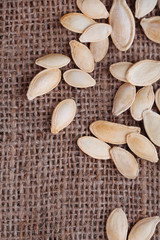 Pumpkin seeds on sackcloth background