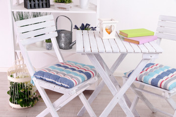 Garden chairs and table with flowers