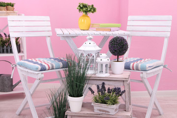Garden chairs and table with flowers
