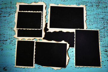 Blank old photos on color wooden background