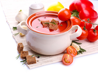 Tasty tomato soup and vegetables, isolated on white