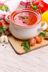 Tasty tomato soup and vegetables, close up