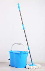 Floor mop and bucket for washing in room © Africa Studio