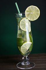 Glass of cocktail with lime and mint