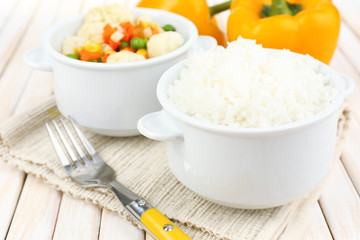 Cooked rice with vegetables on wooden table close up