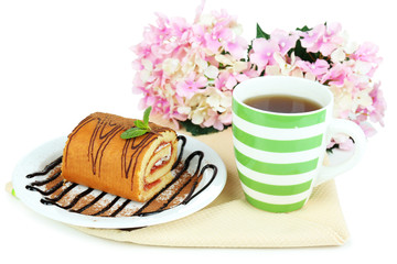 Cup of tea and sweets isolated on white