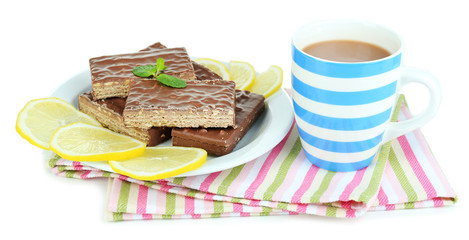 Cup of tea and sweets isolated on white
